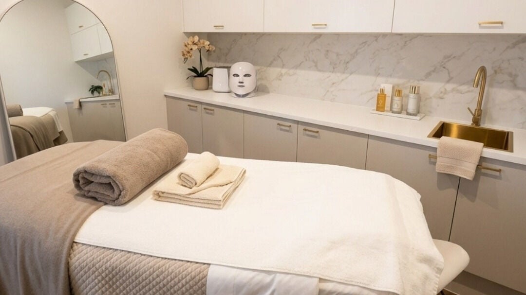 A second treatment room at e-skin with cosy linens and calming decor