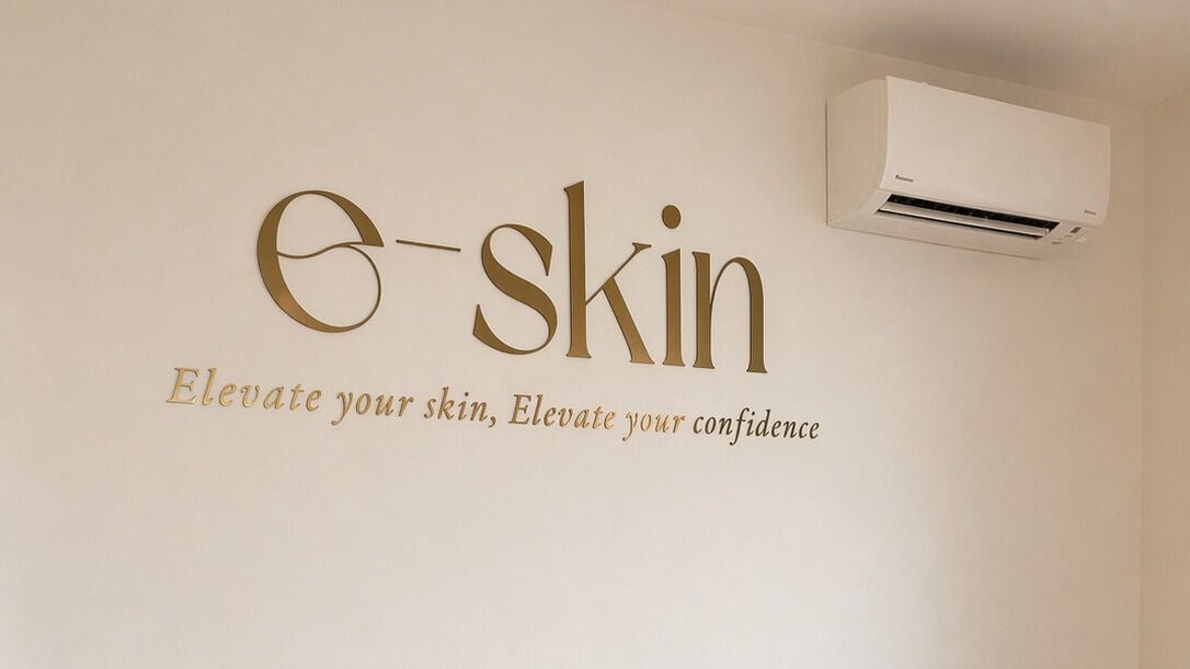 Gold e-skin lettering on the clinic wall reading Elevate your skin, Elevate your confidence